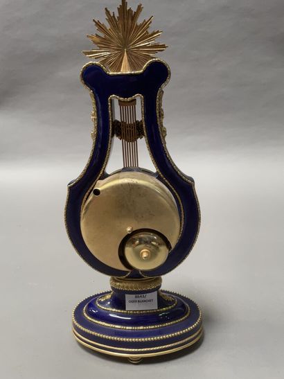 null Lyre clock in blue enamelled porcelain and gilt bronze, the dial showing the...