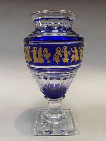 A baluster vase on a foot in cut glass and...