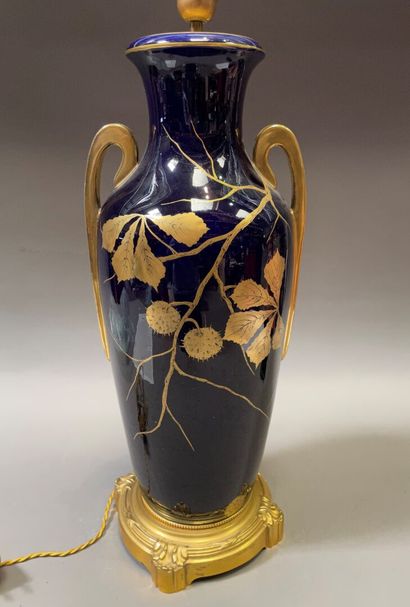 null Important porcelain vase decorated on a blue background with a gilded chestnut...