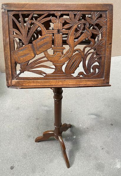 Mahogany lectern decorated with musical instruments,...