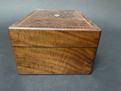 null Walnut veneer case inlaid with a geometric frieze centered on a rhombus and...