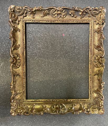 Wood and gilded stucco frame with shell decoration....