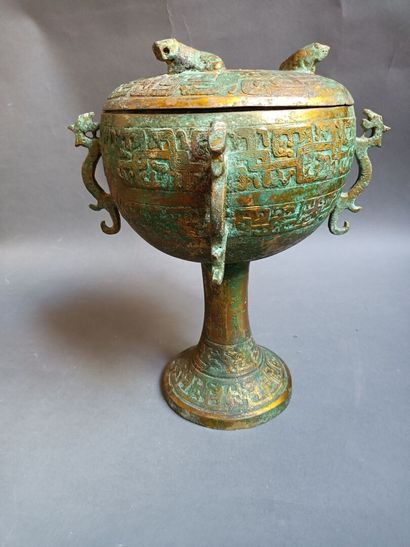 null Covered cup with four handles in oxidized bronze in the taste of Chinese antiquity....