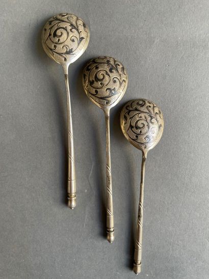 Three silver spoons with black enameled scrolls.

Russian...