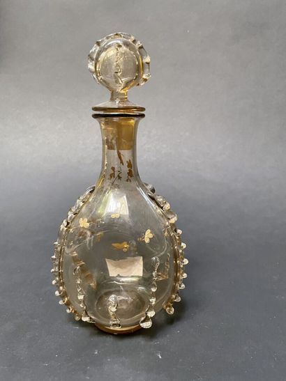 null Glass bottle with staples, gilded branches and butterflies.

In the taste of...