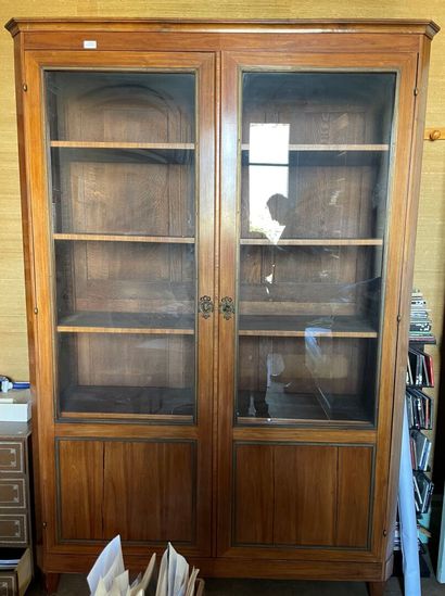 null Rosewood veneer display cabinet, opening with two semi-glazed doors.

Louis...