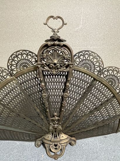 null Fireplace screen in the shape of a fan, the frame in openwork and gilt bronze,...