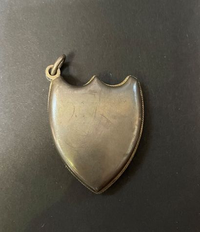 null Silver plated metal pendant, in the shape of a shield, one side decorated with...