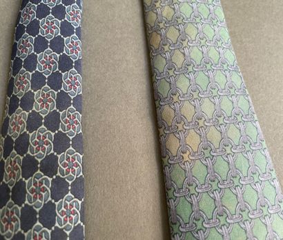 null HERMÈS Paris made in France 
Three silk ties with geometrical patterns in blue,...