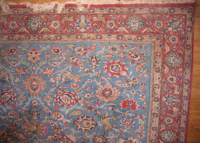 Un tapis persan à fond bleu turquoise et...