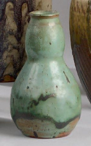 Eugène LION (1867-1945) Lot de trois vases en grès à corps pansu et cols galbés....