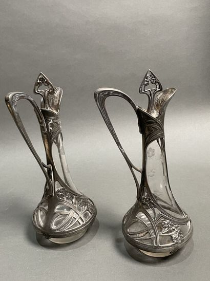null Pair of small glass ewers engraved with flowers, the metal frame marked WMF.
Germany,...