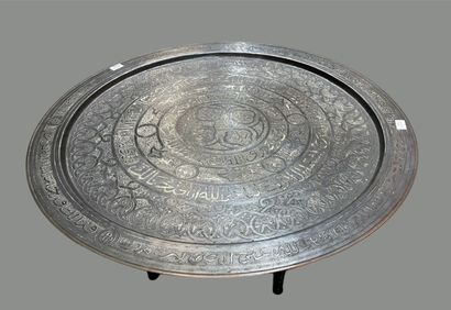null Round engraved brass top. 
Black wooden legs.
Maghreb, 20th century.
Wear and...