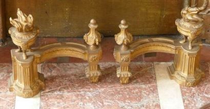 null Pair of ormolu andirons adorned with a vase and a fire pot on a railing. 
Louis...