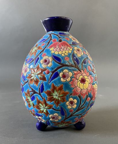 null LONGWY
An ovoid enamel vase decorated with flowers, standing on a tripod base....