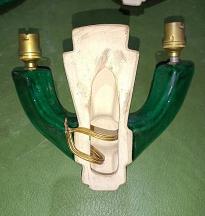 null Set of four two-light green enameled earthenware sconces. 

A sconce of a similar...