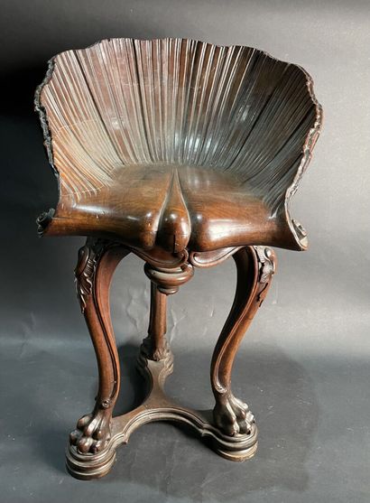 null Mahogany swivel stool, leaf-shaped seat, standing on three lion-shank legs....