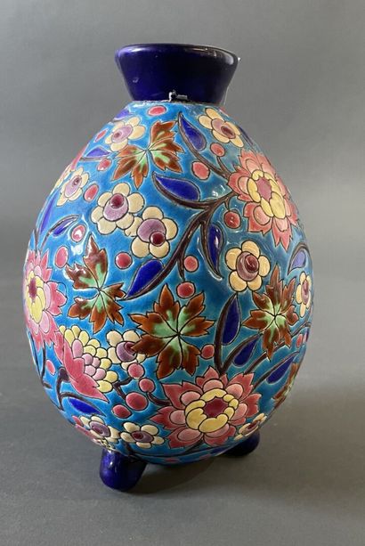 null LONGWY
An ovoid enamel vase decorated with flowers, standing on a tripod base....