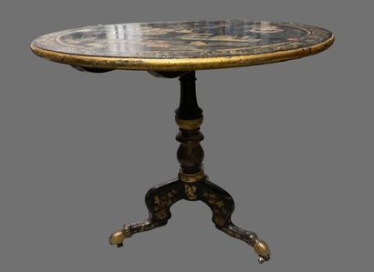 null Pedestal table in blackened and gilded wood, the top decorated in partially...