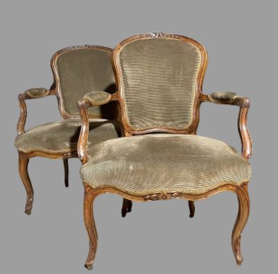 null Pair of cabriolet armchairs in molded natural wood, the backs carved with flowers....