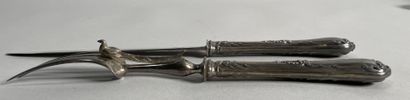 null Cutlery for serving a leg of lamb, the silver handle chased with a leaf motif,...