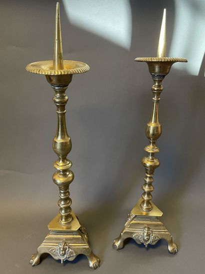 null Pair of ormolu pick-axes with tripod base decorated with cherub heads,
In the...