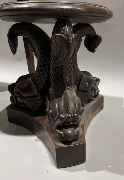 null Carved wooden three-legged stand featuring dolphins.
Height: 40 cm
Accident