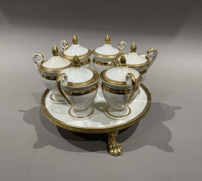 null Suite of six cream jars, baluster form on a display stand with three lion claw...