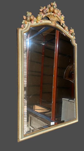 null Polychrome painted wood mirror with pediment carved with a flowering basket....