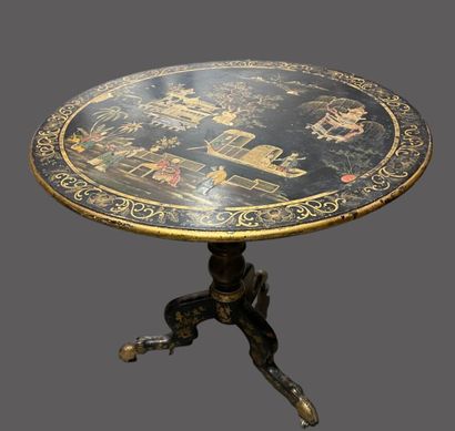 null Pedestal table in blackened and gilded wood, the top decorated in partially...