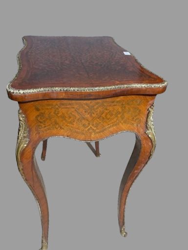 null Veneered work table inlaid with scrolls, opening to a flap and one drawer, curved...