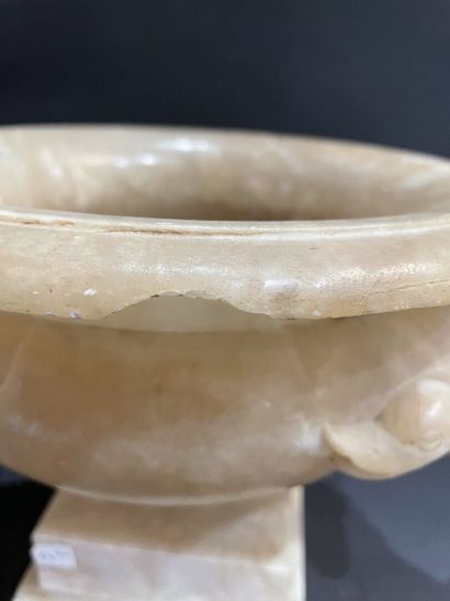 null Two alabaster bowls, one with a snake-shaped handle, the other with a leafy...