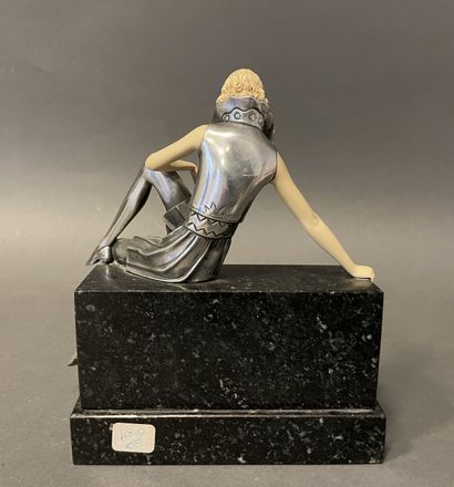 null In the Art Deco style. 
Seated woman
Metal and resin sculpture on a marble base....