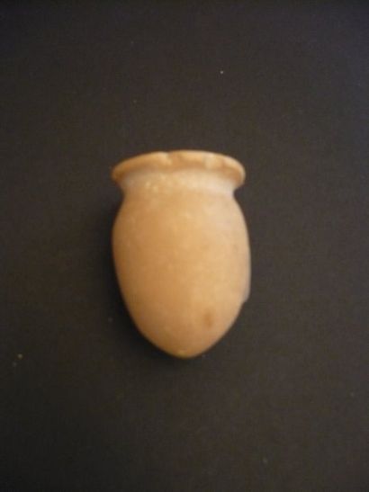  Petit vase à onguent à panse ovoïde et lèvre concave. Calcaire beige. Eclats. Mésopotamie,...