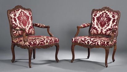 null Paire de fauteuils en hêtre teinté et sculpté à dossier plat, à décor de feuillages...