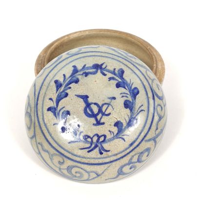Small circular covered box decorated in blue...