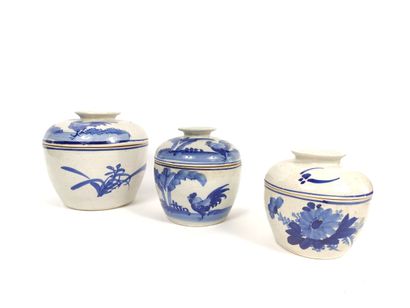  Set of three covered stoneware pots with underglaze blue decoration of foliage,...