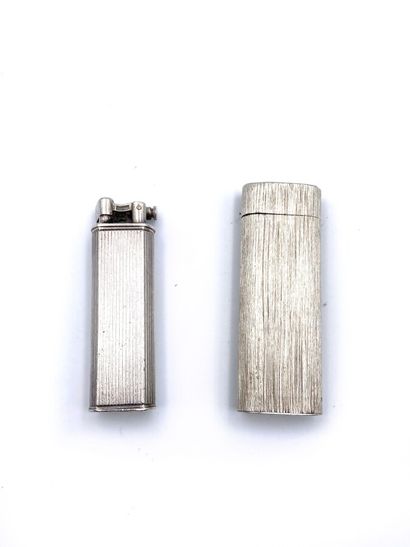  CARTIER and DUNHILL. Two silver lighters (minimum 800 thousandth) chased and gadrooned....