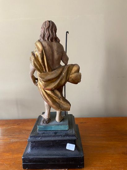  Christ the pilgrim 
 in polychrome carved wood on a blackened wooden pedestal. End...