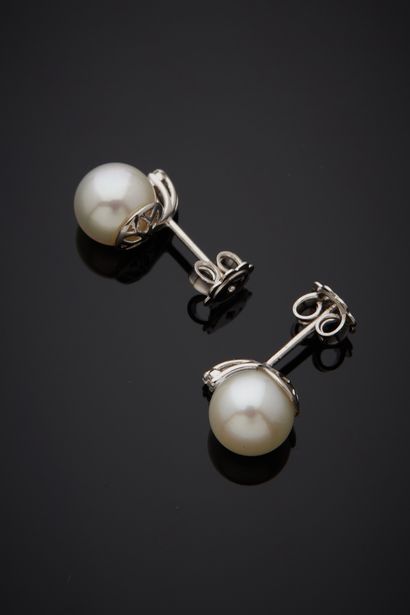  Pair of white gold (750%) EARRINGS each set with a white cultured pearl, topped...