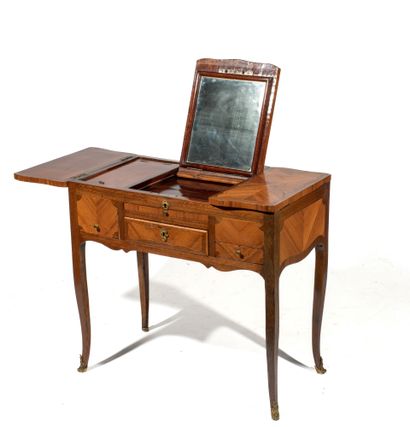 A marquetry veneered dressing table resting...