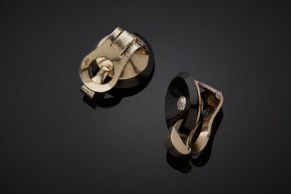  Pair of white gold (750‰) circular EAR CLIPS adorned with a concave onyx disc, flanked...