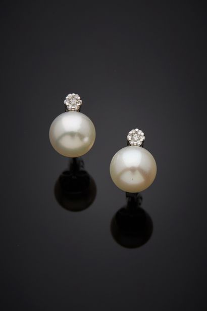  Pair of white gold (750%) EARRINGS each set with a white cultured pearl, topped...