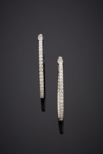  Pair of white gold (750‰) "creole" EARPENDANTS set with a line of brilliant-cut...