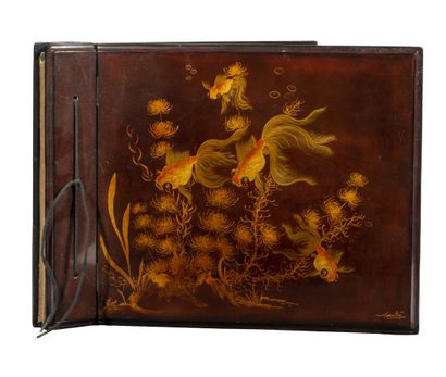 An empty photo album in red lacquer decorated...