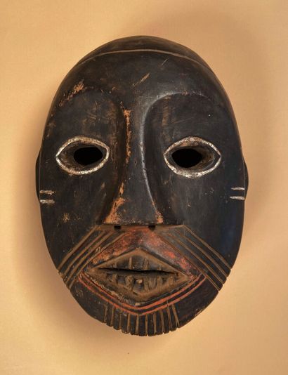 Mask with white rimmed eyes, red stained...