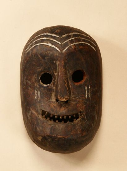Mask with round eyes, one painted red, the...
