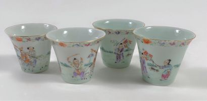 Set of four small cups decorated with characters,...