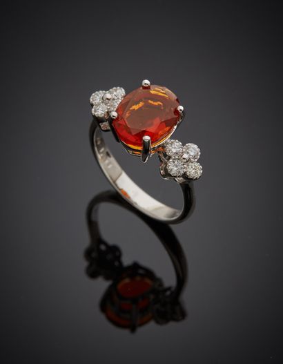  White gold (750‰) ring set with an oval-shaped fire opal, shouldered by eight brilliant-cut...