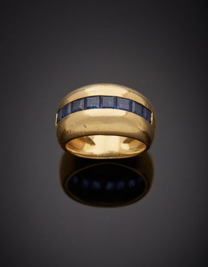  Large domed yellow gold (750‰) RING set with an alignment of calibrated sapphires....